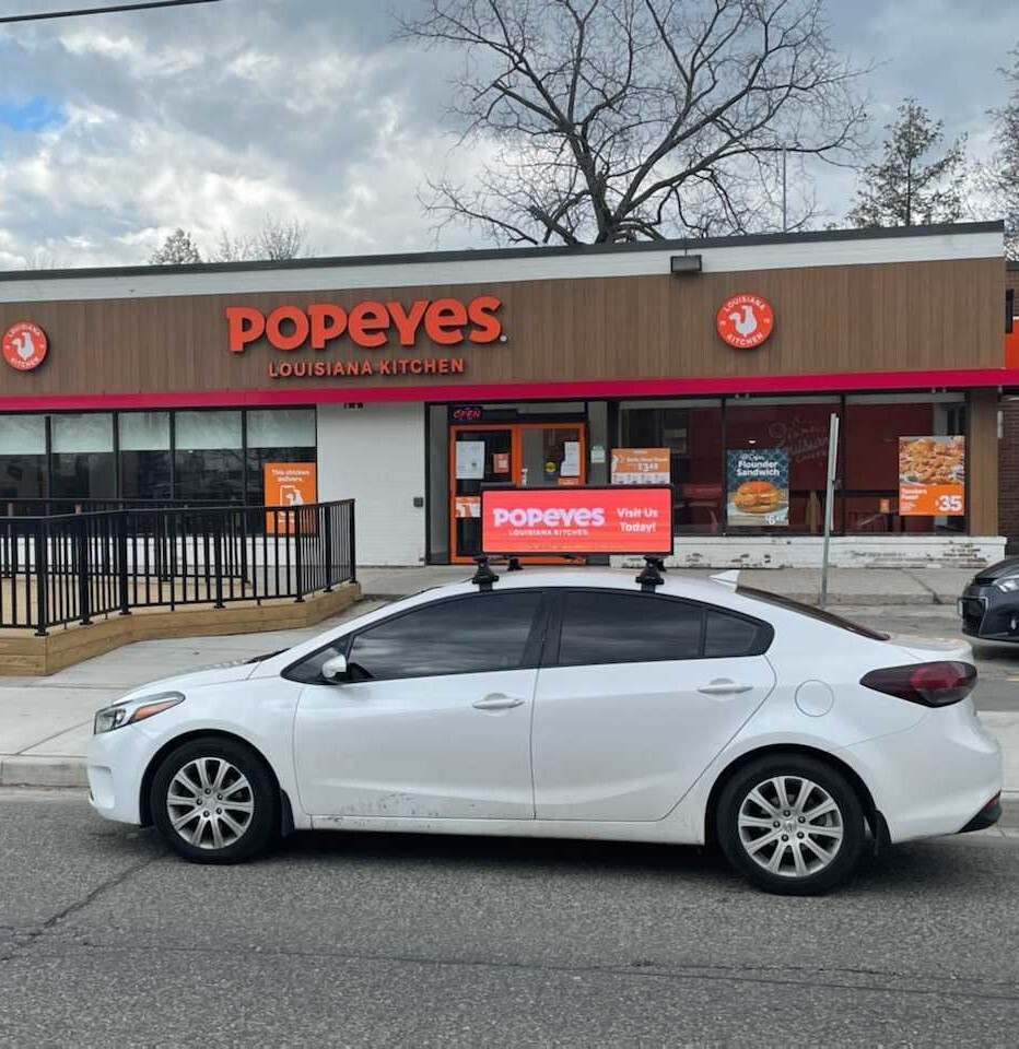 ADVIDR Glow rooftop LED billboard mounted on a car